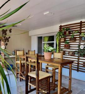 a dining room with wooden tables and chairs at Como en casa Hostel in Posadas