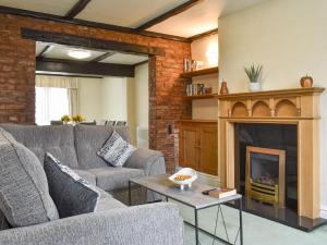 a living room with two couches and a fireplace at Bank Lane House in Freckleton