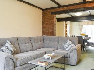 a living room with a couch and a table at Bank Lane House in Freckleton
