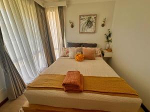 a bedroom with a bed with an orange blanket on it at Ocean Breeze in Perth