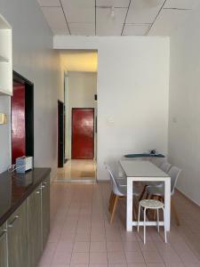 a kitchen with a table and chairs in a room at Best Homestay in Kuala Rompin