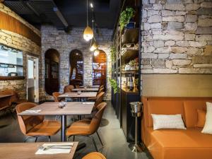 a restaurant with tables and chairs and a brick wall at Mantra Terrace Brisbane in Brisbane +69 photos