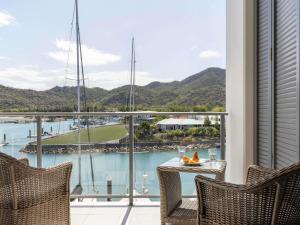 a balcony with a view of a marina at Peppers Blue on Blue in Nelly Bay