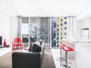 a kitchen and living room with a couch and a table at Mantra Midtown in Brisbane +59 photos