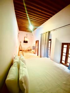 a bedroom with a white bed with a wooden ceiling at Dar cheikh in Fez