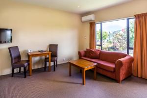 a living room with a couch and a table at Waterfront motel in Blenheim
