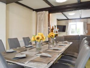 a dining room with a long table and chairs at Bank Lane House in Freckleton