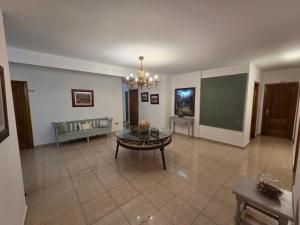 a living room with a table and a chalkboard at Hostal Carlos I in Herrera del Duque