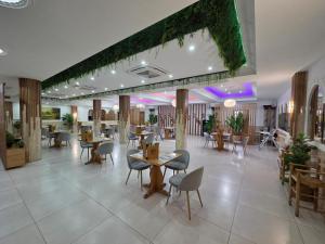 a restaurant with tables and chairs in a room at Hostal Carlos I in Herrera del Duque +20 photos
