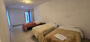 ein Zimmer mit drei Betten in einem Zimmer in der Unterkunft Mi Valle in Cafayate