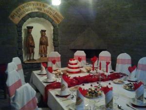 a table with a cake on top of it at Penzión Jánošíkova Krčma in Ružomberok