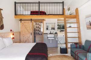 a bedroom with a bunk bed and a couch at Hotel Palomino in Ridgway