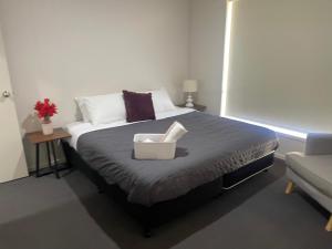 a bedroom with a bed with a basket on it at Accomodation at Lavington in Lavington