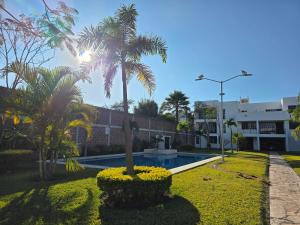 a resort with a swimming pool and palm trees at La Casa Blanca VIP in Tlayecac