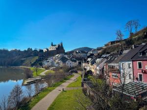 a town on a hill next to a river at Hotel Zunftstube in Saarburg