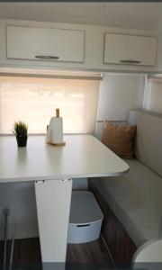 a white table in an rv with a plant on it at Trailer cassa Rodante in Posadas