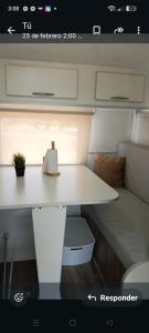a white table with a plant on it in a room at Trailer cassa Rodante in Posadas +8 photos