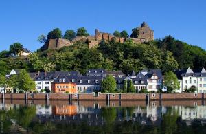 a town with a castle on top of a hill at Hotel Zunftstube in Saarburg +7 photos