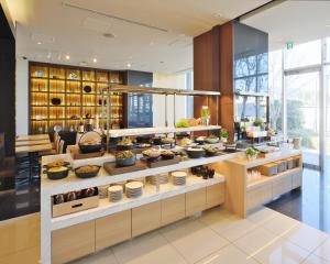 a kitchen with a buffet of food on display at Candeo Hotels Chino in Chino