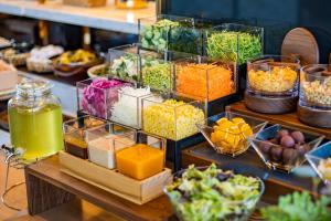 a display of different types of food in glass containers at Candeo Hotels Chino in Chino
