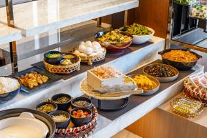 a buffet line with many different types of food at Candeo Hotels Chino in Chino