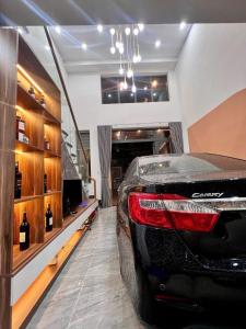 a black car parked in a room with wine bottles at Bhome in Vung Tau