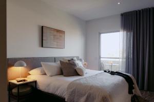 a bedroom with a large bed with a window at Punthill Essendon in Melbourne +59 photos