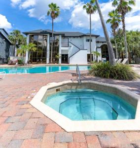 a swimming pool in front of a house at The Fold Hotels Orlando in Orlando