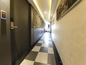 a hallway with a checkered floor in a building at Mora Stay in Busan