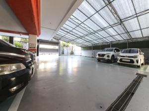 a large garage with two cars parked in it at Mora Stay in Busan