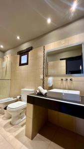 a bathroom with a tub and a toilet and a sink at Hostería Terrazas de la Posta in Purmamarca +10 photos