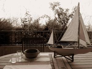 a small sail boat sitting on a table on a deck at Villa Anna "Davvero sulla Spiaggia" in Vasto