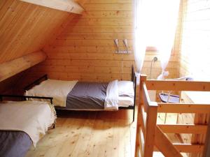 a bedroom with two beds in a log cabin at Poolside Bliss Near Lake in Beaulieu +32 photos