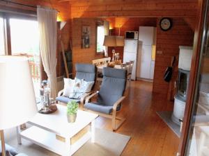 a living room with two chairs and a kitchen at Poolside Bliss Near Lake in Beaulieu