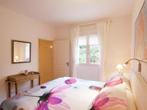 a bedroom with a bed with flowers on it at Rouzède Villa with Pool in La Séguinie +31 photos