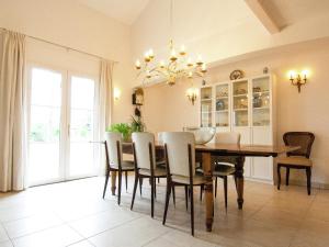a dining room with a wooden table and chairs at Rouzède Villa with Pool in La Séguinie