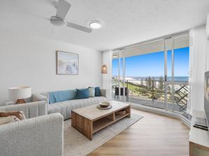 a living room with a couch and a table at Mandolin Beachfront Resort in Alexandra Headland