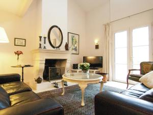 a living room with a couch and a table at Rouzède Villa with Pool in La Séguinie