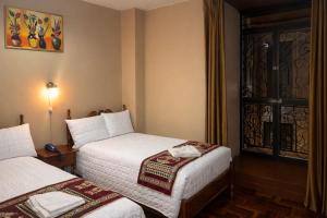 a hotel room with two beds and a window at Viena Internacional B&B - Rooftop in Quito +98 photos