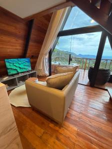 a living room with a couch and a television at Nature Senses Chapadinha in Cavalcante