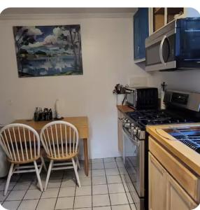 a kitchen with a table and chairs and a stove at Quiet, Convenient Studio Andover Merrimack Valley - Long Stays Only in Andover