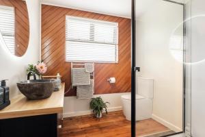 a bathroom with a sink and a toilet at Puna BnB in Matamata