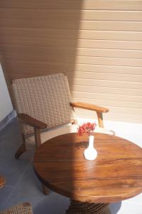 a table and chairs with a vase on a table at Grand Luxcamp Pangandaran by Horison in Pangandaran
