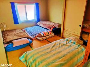 a room with two beds in front of a mirror at 别墅之家オーナーChangeAorB in Kami-furano