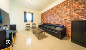 a living room with a couch and a brick wall at Tony's house in Jiaoxi