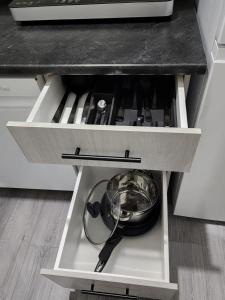 a kitchen drawer with a pot and pans in it at Cozy Home basement suite with private separate entrance in Winnipeg