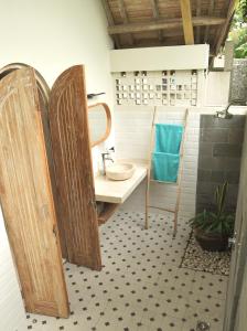 a bathroom with a sink and a mirror at Graha Ayoe Resort in Sidemen