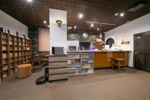 a library with a book shelf and a counter at Personal Hotel You in Takeo