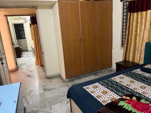 a bedroom with a bed and a wardrobe and a room at Aijaz Arcade in Hyderabad