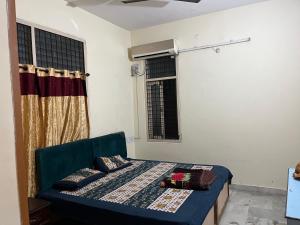 a small bedroom with a bed and a window at Aijaz Arcade in Hyderabad